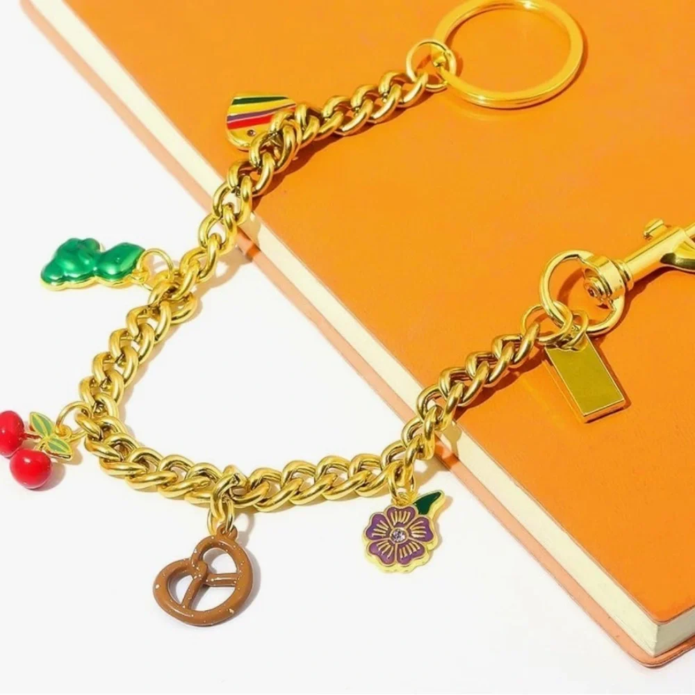 Purse bag charm in gold links with cherry pretzel flower Dino clips on bag